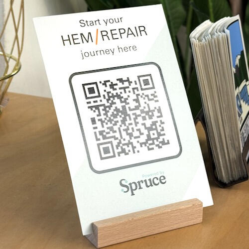 Intake QR Card A card on display that shows a QR code and says "start your hem/repair journey here"